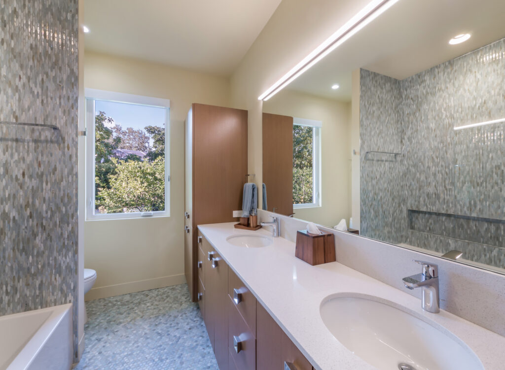 Custom-designed Sarasota bathroom with wood cabinetry and watercolor tile