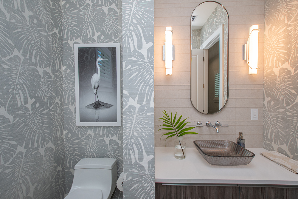 Neutral bathroom with tropical-print wallpaper in Nokomis, Florida