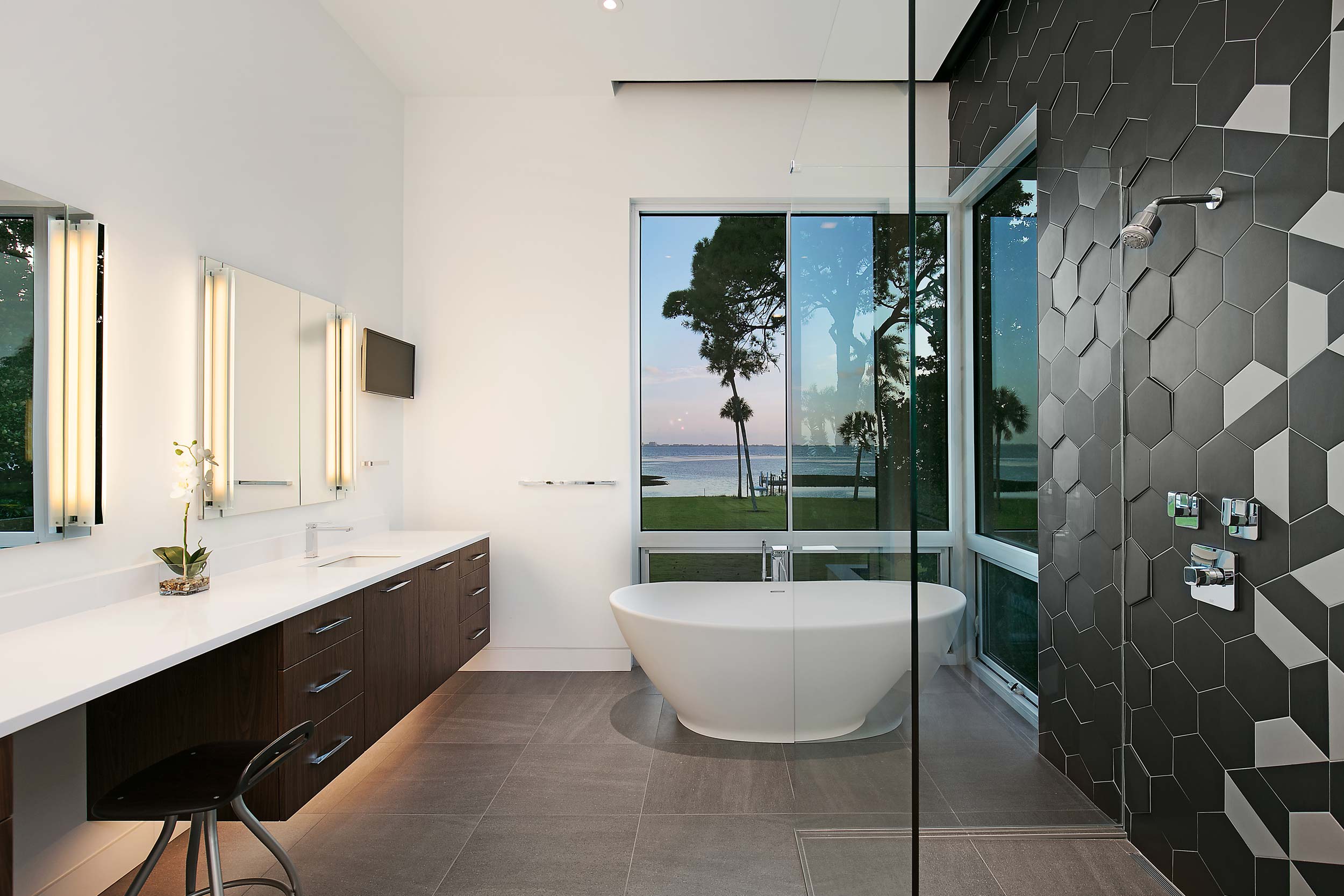 Modern bathroom design with black tile overlooking the water in Sarasota, Florida